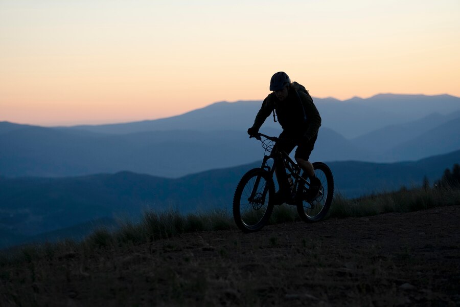 Trail header. Silhouette of bike rider on trail.